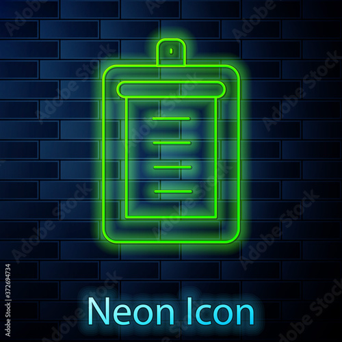 Glowing neon line Clipboard with checklist icon isolated on brick wall background. Control list symbol. Survey poll or questionnaire feedback form. Vector.