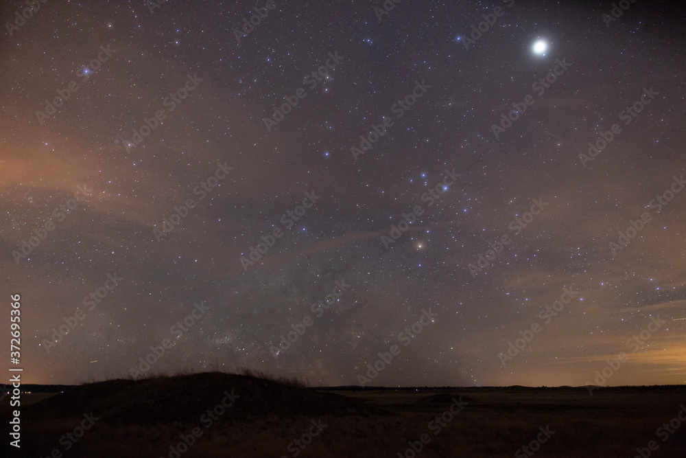 Thin clouds obscure Milky Way stars over a vast prairie Thin clouds obscure Milky Way stars over a vast prairie