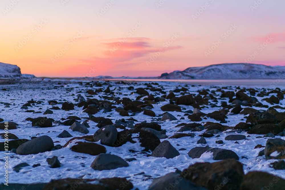 A field of frozen lava overgrown with moss at the foot of a mountain in Iceland in winter. Winter natural landscape A field of frozen lava overgrown with moss at the foot of a mountain in Iceland in winter. Winter natural landscape