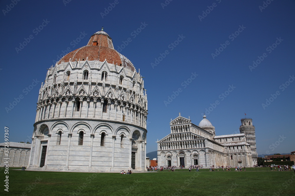 View of Pisa Baptistery with Leaning Tower and the Cathedral in Pisa, Italy