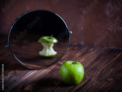 Apple reflecting in the mirror surrealistic picture abstract vision , concept you are not you how others see you how you see yourself photo