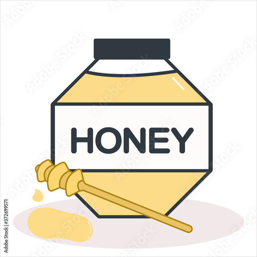 A jar of fresh flower honey with a wooden honey stick and honey drops beside