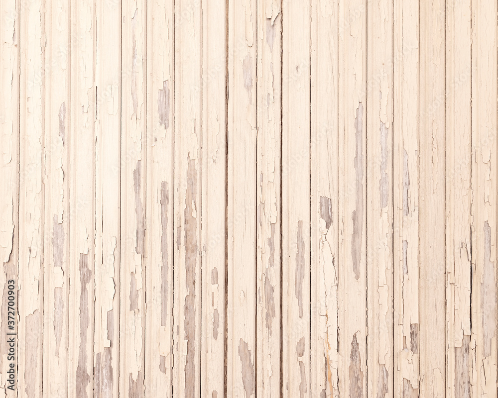 Fototapeta premium old beige grungy paint blisters on vertical wooden planks