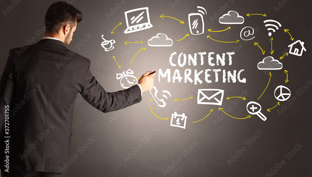 businessman drawing social media icons with CONTENT MARKETING inscription, new media concept businessman drawing social media icons with CONTENT MARKETING inscription, new media concept