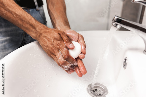 A man washes his hands with soap 