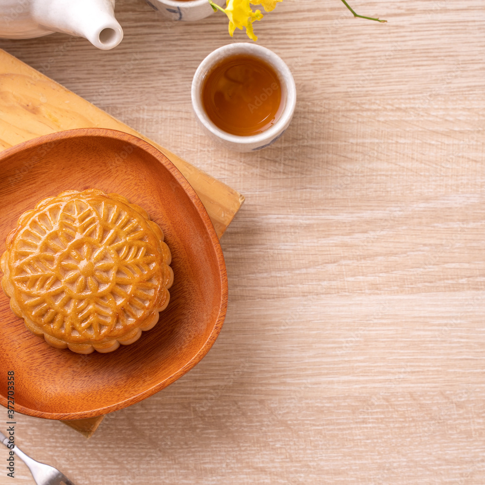 Mid-Autumn Festival holiday concept design of moon cake, mooncakes, tea set on bright wooden table with copy space, top view, flat lay, overhead shot Mid-Autumn Festival holiday concept design of moon cake, mooncakes, tea set on bright wooden table with copy space, top view, flat lay, overhead shot