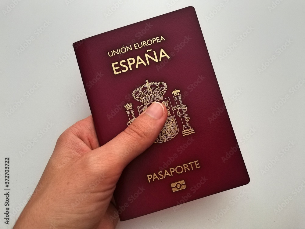  hand of a woman with spanish passport, european union passport