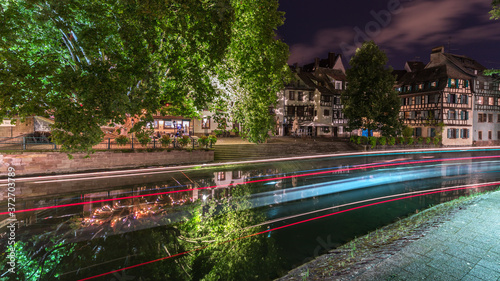 The water Reflection and light trails at night in the little France in Strasbourg in France