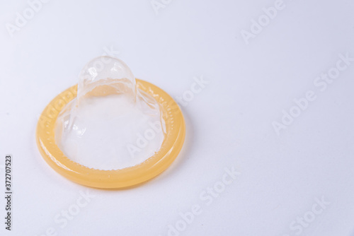 Latex condom on white background