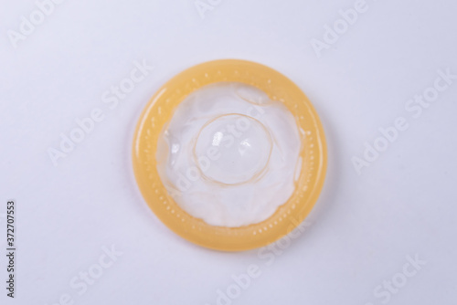 Latex condom on white background