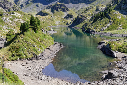 The green mountain lake know as Lac Longet between hills photo