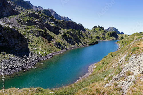 Fototapeta Naklejka Na Ścianę i Meble -  A long blue lake in the mountains