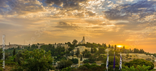 Beautiful sunrise panorama of Mount Zion: Dormition Abbey, Jerusalem university college and greek ceminary; with walls of Jerusalem's Old City, leading up to the Tower of David and Jaffa Gate