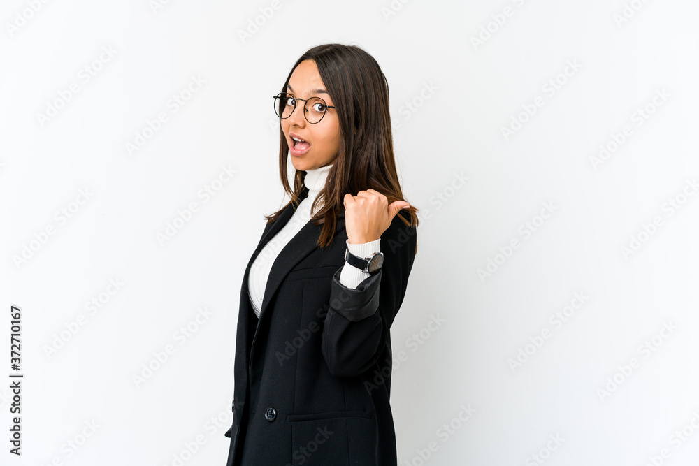 Young mixed race business woman isolated on white background points with thumb finger away, laughing and carefree. Young mixed race business woman isolated on white background points with thumb finger away, laughing and carefree.