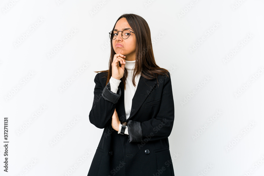 Young mixed race business woman isolated on white background suspicious, uncertain, examining you. Young mixed race business woman isolated on white background suspicious, uncertain, examining you.