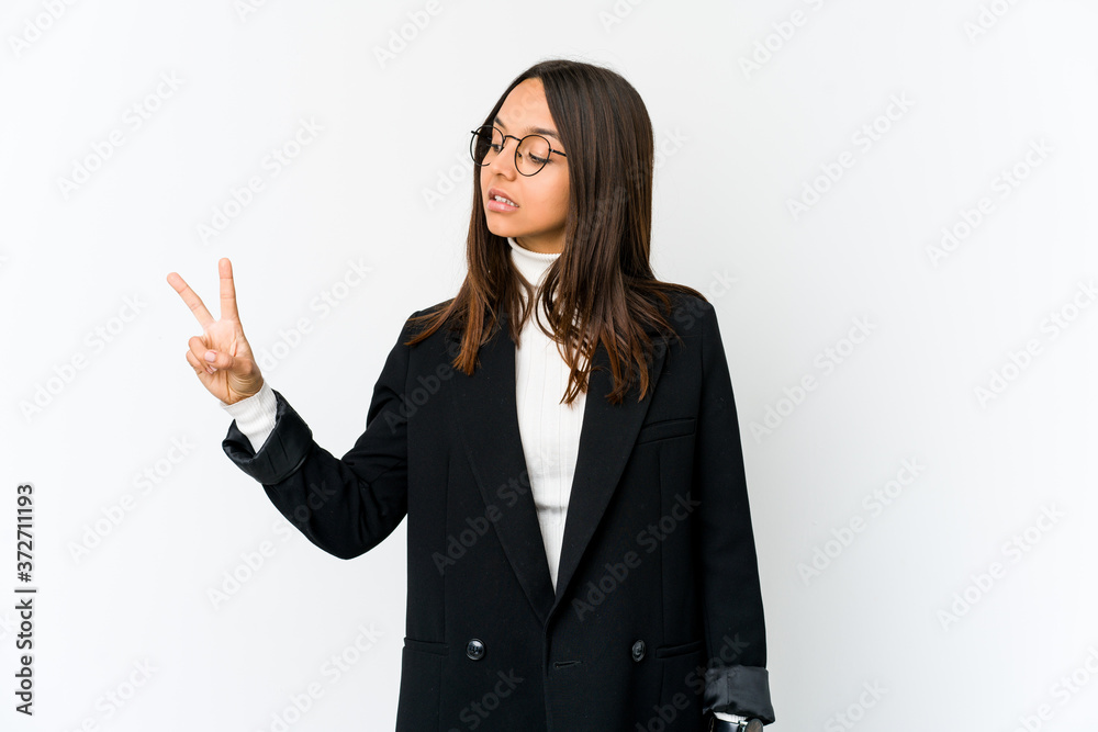 Young mixed race business woman isolated on white background joyful and carefree showing a peace symbol with fingers. Young mixed race business woman isolated on white background joyful and carefree showing a peace symbol with fingers.