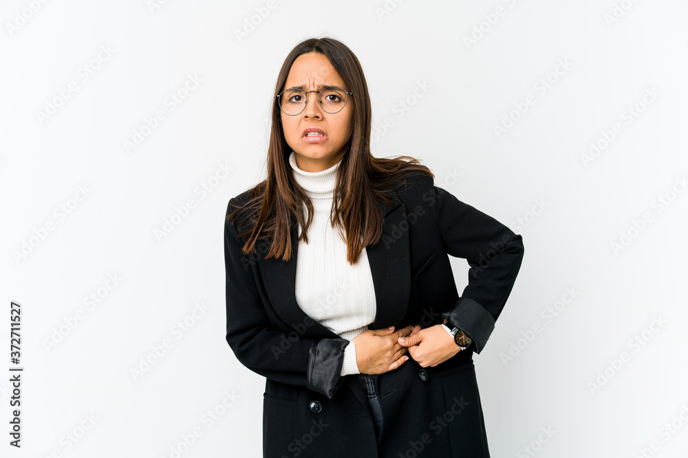 Young mixed race business woman isolated on white background having a liver pain, stomach ache. Young mixed race business woman isolated on white background having a liver pain, stomach ache.