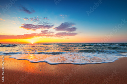 Beach sunrise over the tropical sea