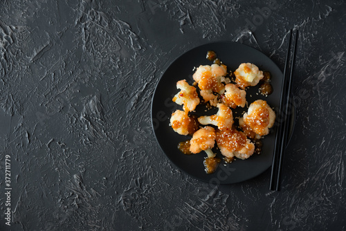 Buffalo barbecue cauliflower on dark background. Top view. Summer food concept