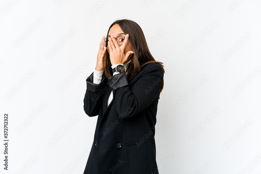 Young mixed race business woman isolated on white background blink through fingers frightened and nervous. Young mixed race business woman isolated on white background blink through fingers frightened and nervous.