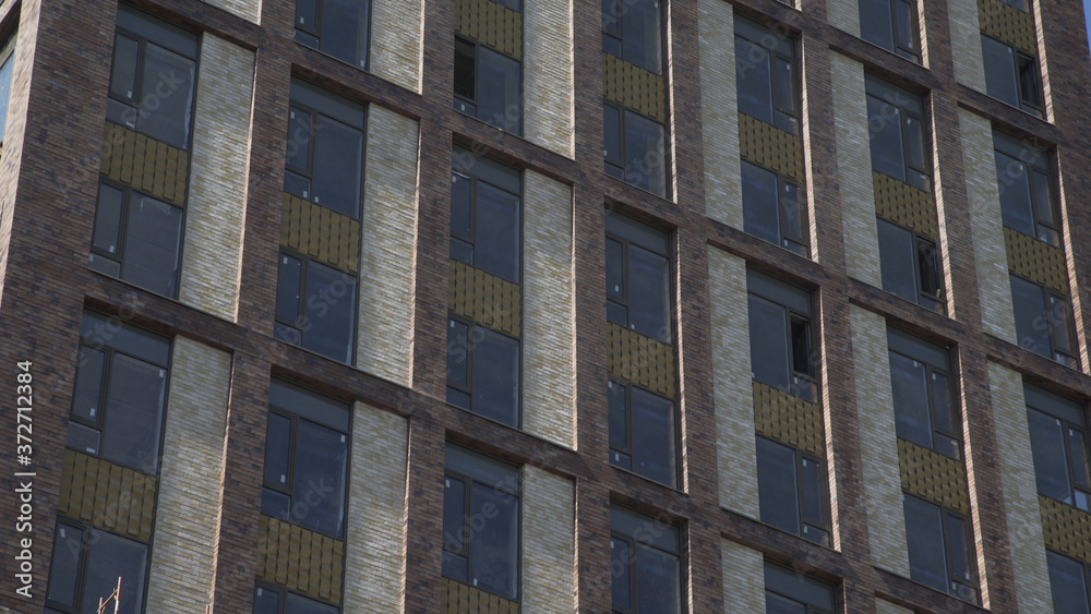Generic day time establishing exterior brick apartment loft building in one of the districts urban city.