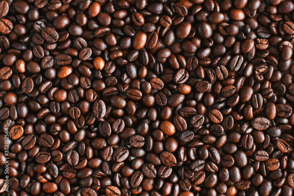 Top view of roasted aromatic coffee beans, which will then be used to prepare an invigorating coffee drink. An ingredient for espresso. Top view of roasted aromatic coffee beans, which will then be used to prepare an invigorating coffee drink. An ingredient for espresso.