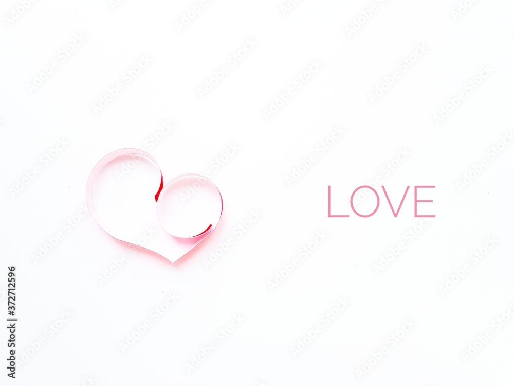 The heart is made of red paper on a white background. Love in English. Valentine's Day.