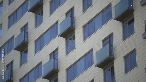 Close up shot of residential building. Close up Of An Apartment Blocks. The building features exterior with small balconies