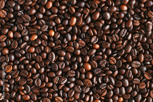 Top view of roasted aromatic coffee beans  which will then be used to prepare an invigorating coffee drink. An ingredient for espresso.