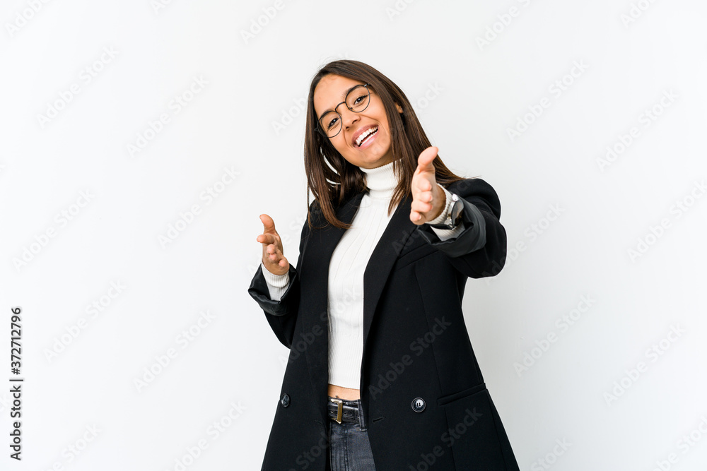 Young mixed race business woman isolated on white background feels confident giving a hug to the camera. Young mixed race business woman isolated on white background feels confident giving a hug to the camera.