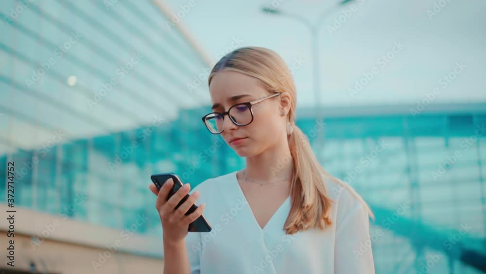 Unhappy face young businesswoman with glasses walking use phone look around serious in street city adult lifestyle female smartphone beautiful technology slow motion Unhappy face young businesswoman with glasses walking use phone look around serious in street city adult lifestyle female smartphone beautiful technology slow motion