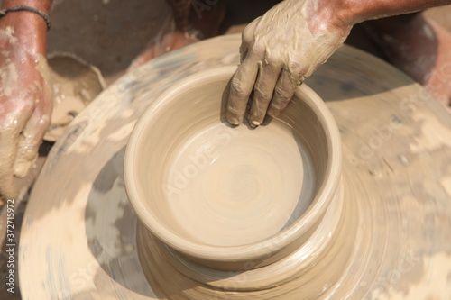 potter at work, clay making pot