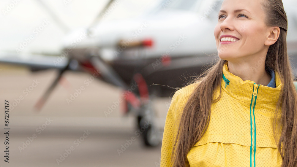 Young woman in front of the airplane Young woman in front of the airplane