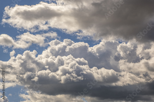 Blue sky background with big white tiny stratus cirrus striped clouds