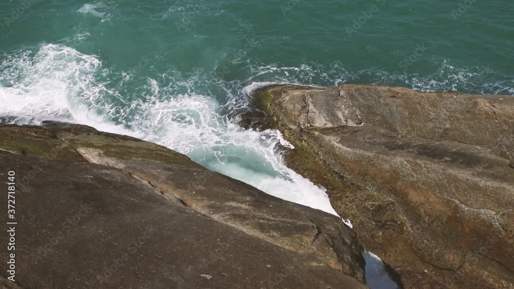Top view of the ocean waves hitting against the rocks Top view of the ocean waves hitting against the rocks