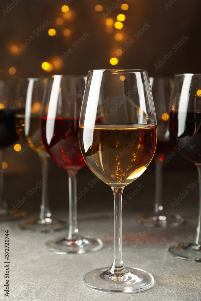 Glasses of wine against background with blurred lights Glasses of wine against background with blurred lights