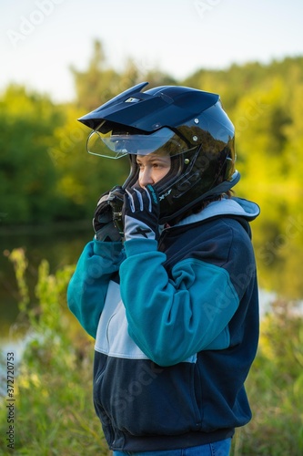 Girl in helmet and gloves in the forest