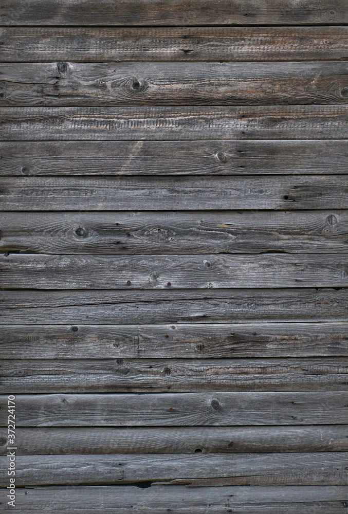 Gray old planks for background. The vertical location. Weathered Barn Boards