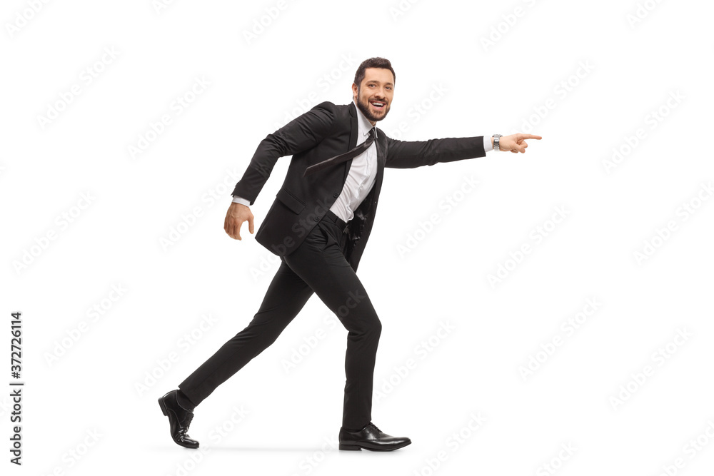 Handsome man in a black suit running and pointing Handsome man in a black suit running and pointing