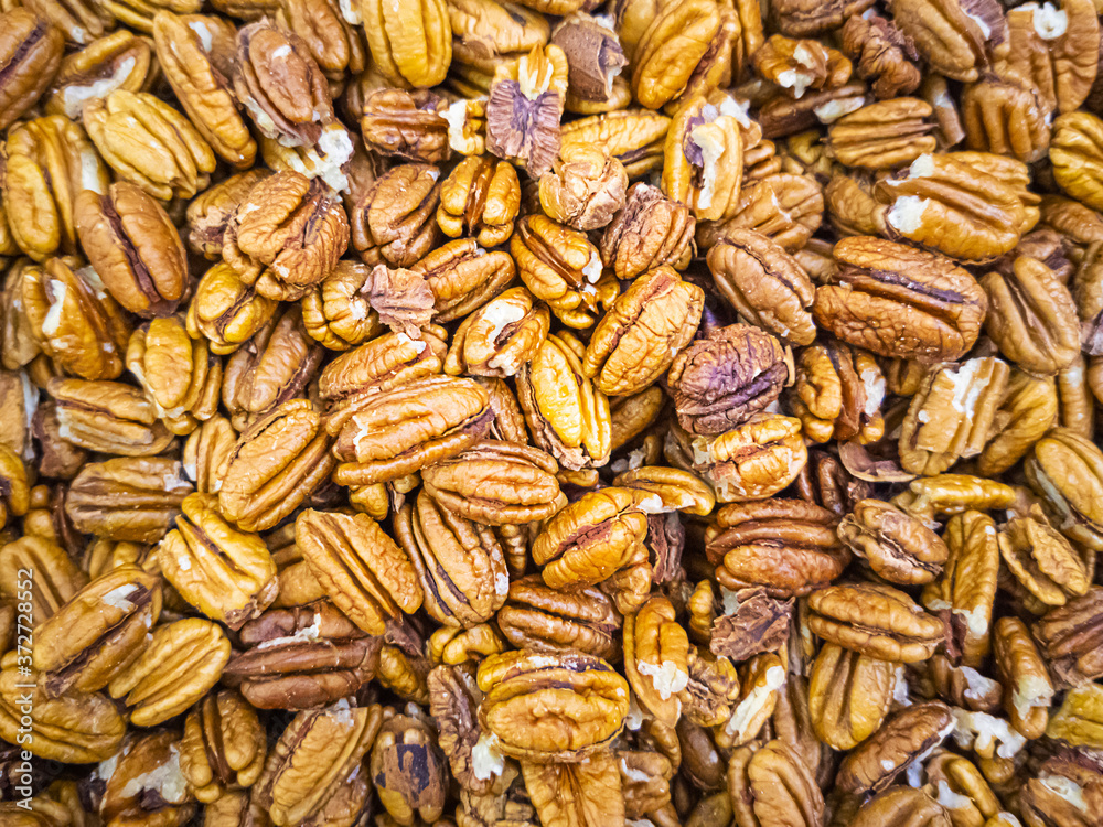 Pecan nut close up. Lots of nuts in the market. Healthy organic food concept.