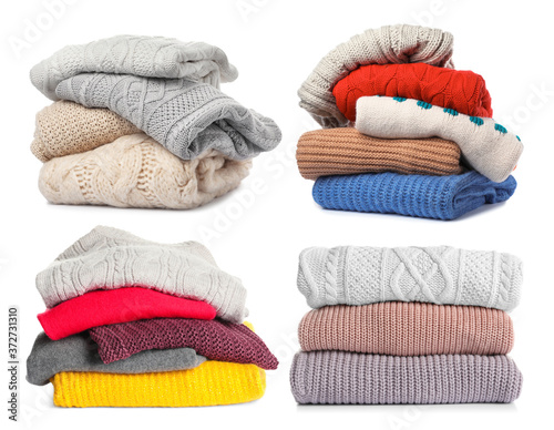 Set of folded and stacked sweaters on white background