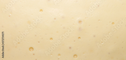 The smooth texture of the white creamy chocolate.White chocolate background.
