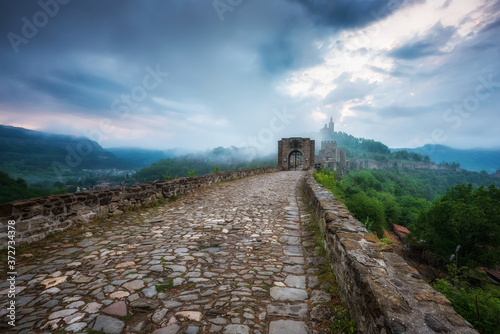 Beautiful view with spring morning mists in front of the main gate of the Tzarevetz fortress, Veliko Tarnovo, Bulgaria photo