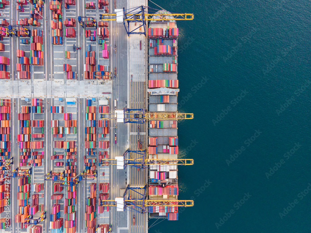 Fototapeta premium Container , container ship in export and import business and logistics. Shipping cargo to harbor by crane. Water transport International. Aerial view and top view.