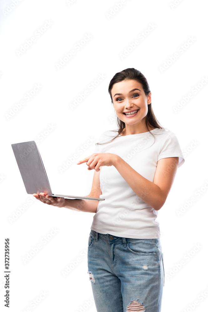 brunette woman in white t-shirt pointing with finger at laptop laptop isolated on white brunette woman in white t-shirt pointing with finger at laptop laptop isolated on white