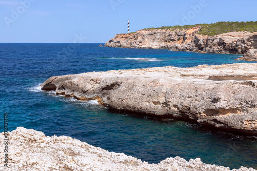 Seascape. The bay Es Cap Blanc and the lighthouse Far Des Moscarter. Ibiza, Balearic Islands, Spain