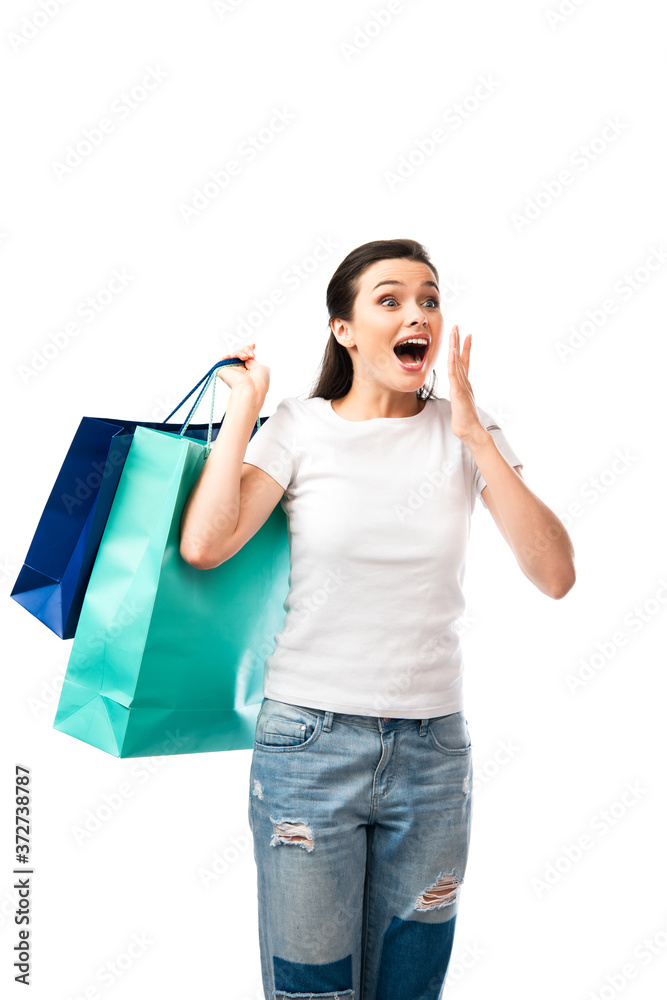 surprised woman holding shopping bags isolated on white surprised woman holding shopping bags isolated on white