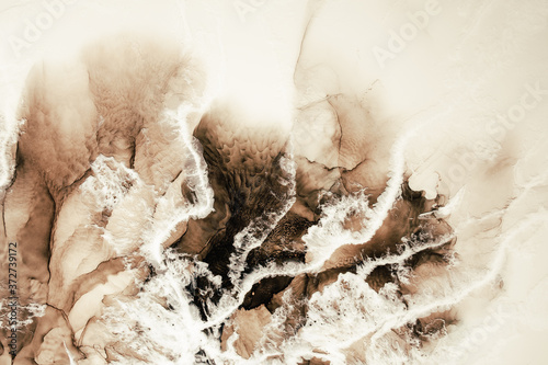Marble background. Acrylic ink water. Brown beige white mineral stone texture. Creative abstract frozen foam art design with wave pattern. Luxury stained surface. © golubovy