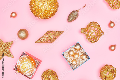 golden christmas decoration on pastel pink background, copy space, layout