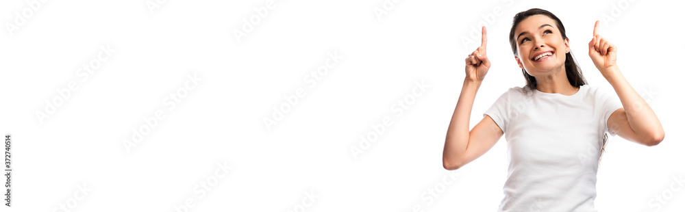 panoramic concept brunette woman in white t-shirt pointing with fingers and looking up isolated on white panoramic concept brunette woman in white t-shirt pointing with fingers and looking up isolated on white